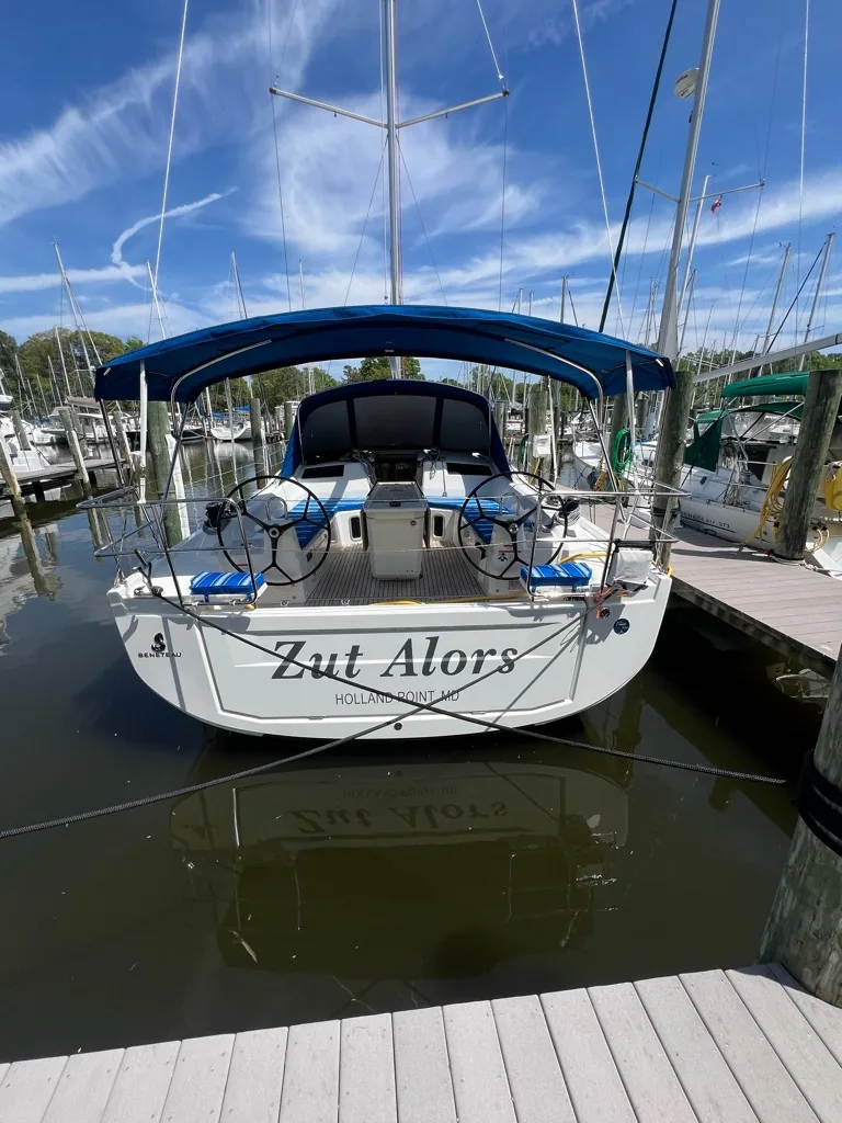 Stern of Zut Alors at the dock, with the boat name visible across the transom.
