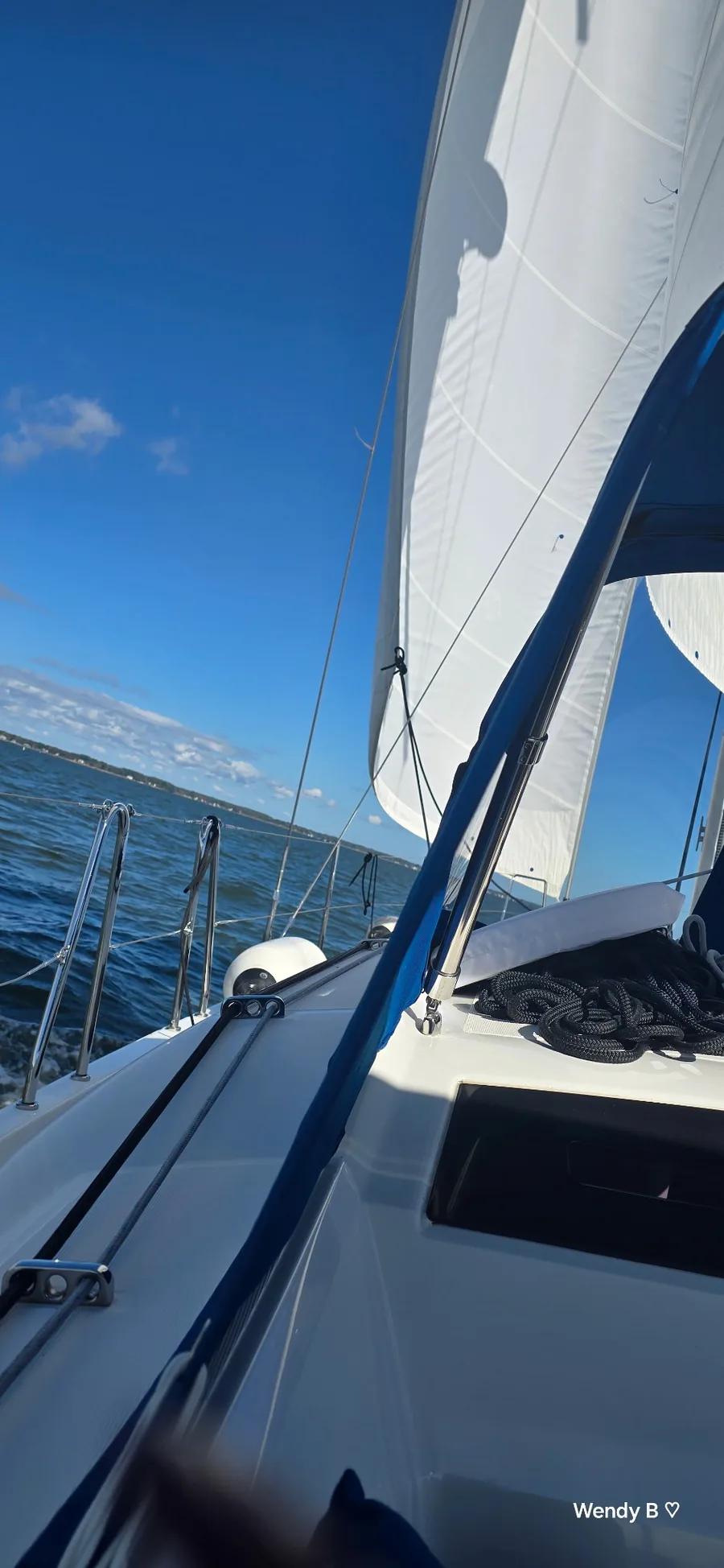 Sail and rigging of Zut Alors against a deep blue sky.